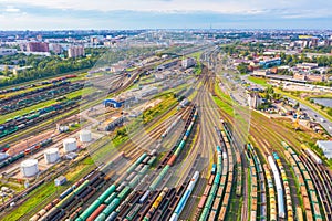 Cargo railway carriage. Aerial view from flying drone of colorful freight trains on the railway sort facility. Wagons with goods