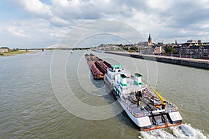 Cargo riverboat passing the Dutch city Nijmegen