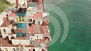 Cargo ship aground at sea.