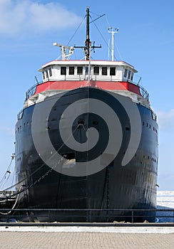 Cargo ship anchored at dock photo