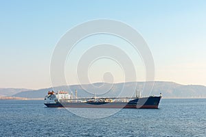 Cargo ship on the background of mountains