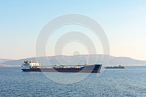 Cargo ship on the background of mountains