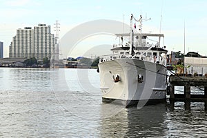 Cargo ship on Chao Phraya river and city scape in Bangkok, Thailand