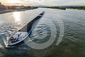 Cargo ship with coal bulk load on the river Rhine in Mainz, Germ