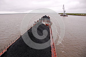 Cargo ship with coal at Kolyma river Russia outback