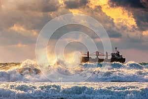 Cargo ship with containers in sunrise light