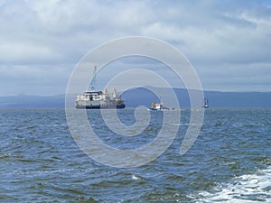 The cargo ship with the crane, the top view. Pipelaying barge.