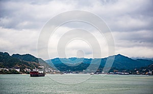 Cargo ship cruising on Yangtze river in rainy day