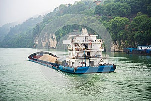 Cargo ship cruising on Yangtze river in rainy day