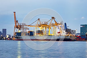 Cargo ship at dock with sky background.