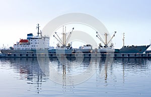 Cargo ship docked and loading in port fully