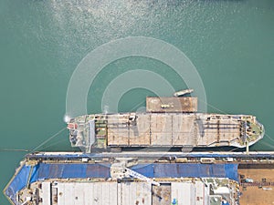 Cargo ship docking at the port waiting for loading container for logistic and transportation