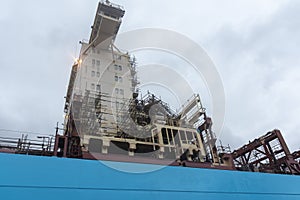 Cargo ship in a dry dock, view on the superstructure.