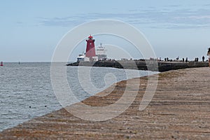 Cargo ship entering Dublin harbour at Poolbeg lighthouse.