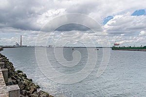 Cargo ship entering Dublin harbour at Poolbeg lighthouse. photo