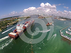 Cargo ship enters port aerial view