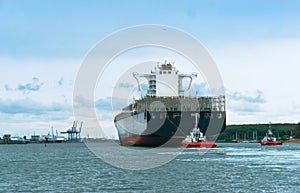 Cargo ship with escort, empty container ship