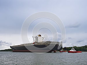 Cargo ship with escort, empty container ship