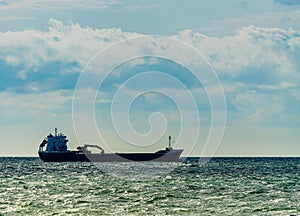 Cargo ship with an excavator mounted on its hull