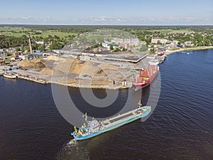 Cargo ship getting load with firewood