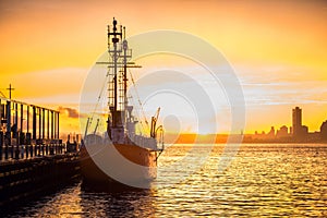 Cargo ship in the harbor at commercial port at sunset time