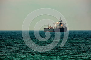 cargo ship on the horizon at sea