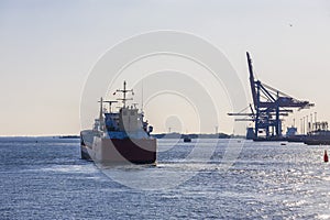 Cargo ship on its way to the open sea from a port