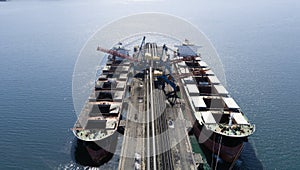 Cargo ship loading in coal cargo terminal