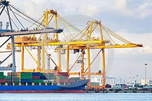 Cargo ship loading cargo container with crane at port