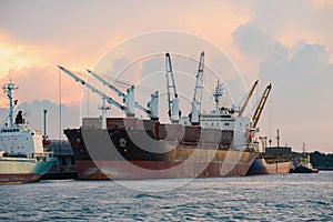 Cargo ship loading containers at sunshine