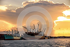 Cargo ship loading containers at sunshine