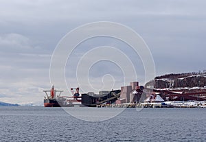 Cargo ship loading iron ore at the Port of Narvik in northern Norway on a winter day