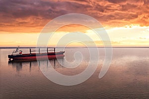 Cargo ship in the open sea at the beautiful sunset. Aerial top view.Shipping. Grain export