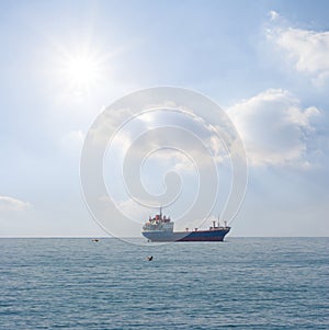 cargo ship in open sea at sunny day