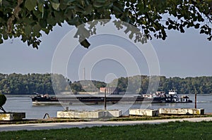 Cargo ship pass along the Ruse port at Danube river