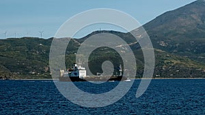 Cargo ship pass harbor of Milos island, Greece