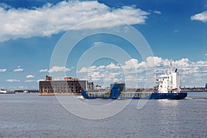 Cargo ship passes by the Alexander fort near Kronstadt, Russia