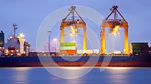 Cargo ship in port at dusk