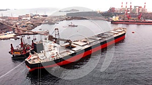 Cargo ship in the process of loading minerals from a mine for export