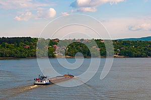 Cargo ship on the river transporting sand