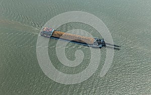 Cargo ship on the river transporting sand