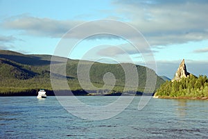 Cargo ship and rock at Kolyma river Russia