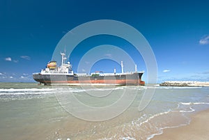 Cargo ship run aground on rocky shore