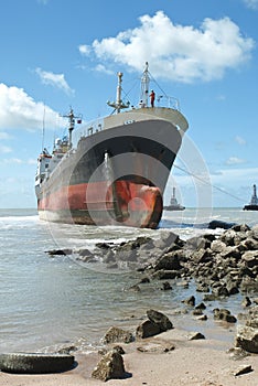 Cargo ship run aground on rocky shore