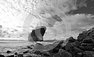 Cargo ship run aground on rocky shore