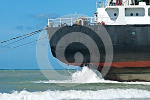 Cargo ship run aground on rocky shore