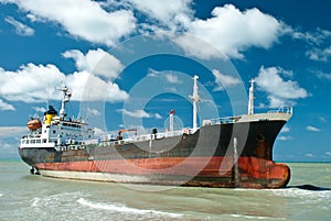 Cargo ship run aground on rocky shore