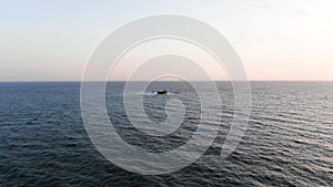 Cargo ship sailing in a clear ocean. Aerial view Seacape. Mediterranean Sea. Cyprus. City resort. Shooting from the