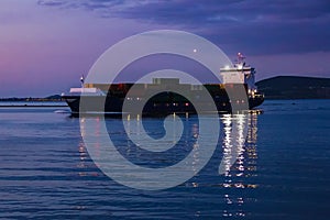 Cargo ship sailing at night