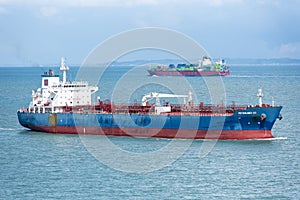 Cargo ship sailing through peaceful, calm, blue sea.